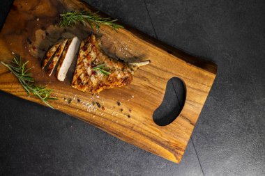 pork cutlet with a bone on rosemary and pepper