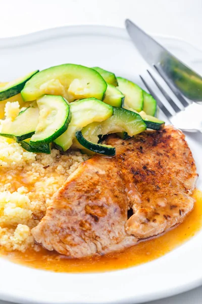 pork meat with zucchini salad and couscous