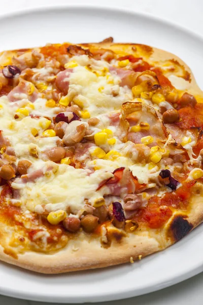 homemade pizza with bacon, corn and beans