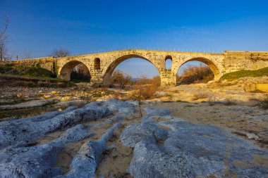 Pont Julien, roman stone arch bridge over Calavon river, Provence, France