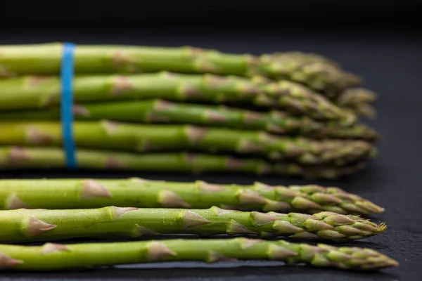 stock image Green asparagus on black background