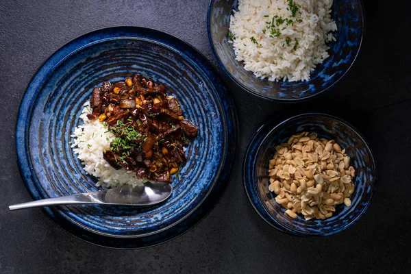 stock image beef kung pao with peanuts and rice