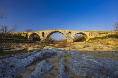 Pont Julien, roman stone arch bridge over Calavon river, Provence, France