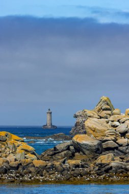 Coast with Phare du Four near Argenton in Brittany, France clipart