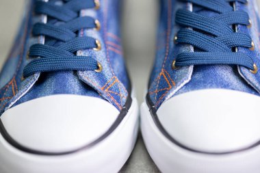 close up of denim sneakers