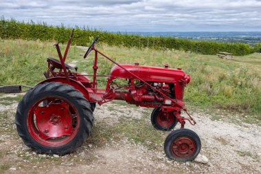 Red tractor near Monbazillac castle (Chateau de Monbazillac), Dordogne department, Aquitaine, France clipart