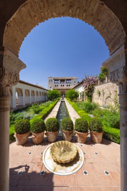 Merkezi çeşmeli süs bahçesi ve Generalife Sarayı, Alhambra, Granada, Endülüs, İspanya 'da bir Fas kemerinden görünen uzun bir su kanalı.