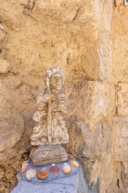 Aziz James 'in yıpranmış heykeli elinde deniz kabuklarıyla süslenmiş baston, Castrojeriz' de Camino de Santiago, İspanya 'da bulunuyor.