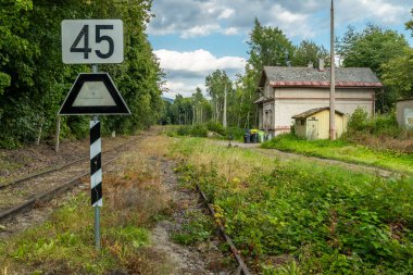 Abandoned railroad tracks leading past a railway station building in Czechia