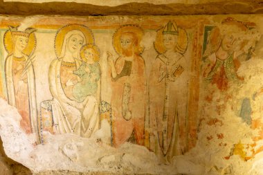 Medieval fresco depicting Madonna and Child surrounded by various saints and holy figures