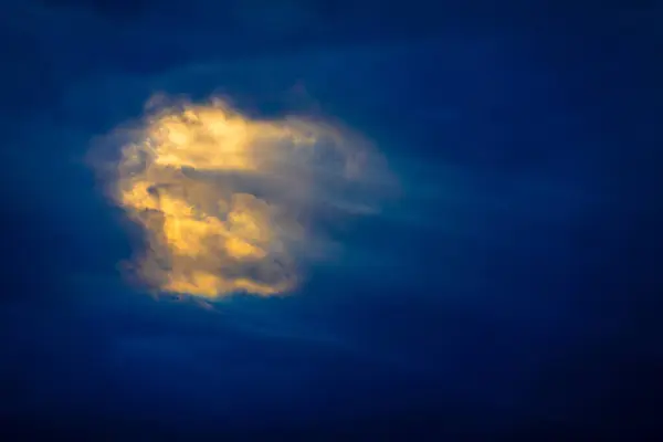 Striking Image Capturing Single Cloud Brightly Lit Sunlight Dark Twilight Stock Photo