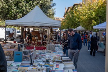 Arezzo, İtalya - 2 Kasım 2024: Ziyaretçiler, Arezzo tarihi merkezindeki aylık pazarda, sokak ve meydanlar boyunca satıcıların sergilediği eşyaları araştırarak antikalara göz atıyor