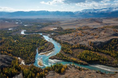 Autumn landscape showcasing mountain valley, winding turquoise river, and mixed forest with orange and green foliage. Majestic peaks and expansive sky create breathtaking scenery evoking tranquility  clipart