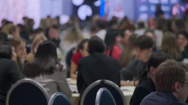 Bir iş konferansına katılan insanlar fikirlerini ve iletişim yollarını paylaştılar. Pek çok katılımcıyla dolu canlı bir atmosfer, işbirliği fırsatları sunuyor 