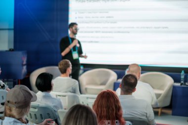 Profesyonel ortamdaki özenli seyircilere beyaz tahtayla sunan konferans konuşmacısı