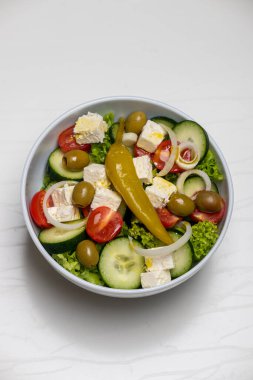 greek salad on white marble