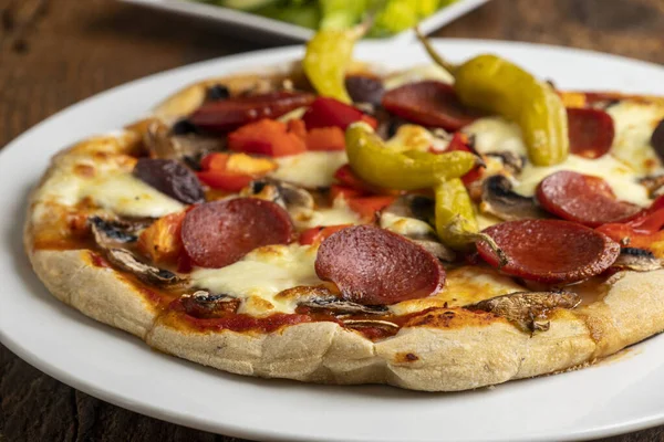 stock image pizza with salami and peperoni