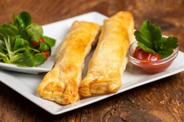 frankfurter in puff pastry with salad