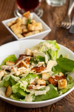 caesar salad on dark wood