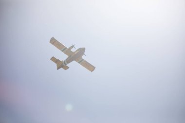 fire fighting plane flying through smoke after fighting a fire in the boise foothills clipart