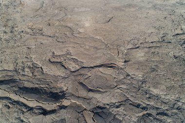 A detailed photo showcasing the rugged texture of dry, cracked earth in a desert environment, highlighting arid and barren natural landscapes at jordan craters clipart