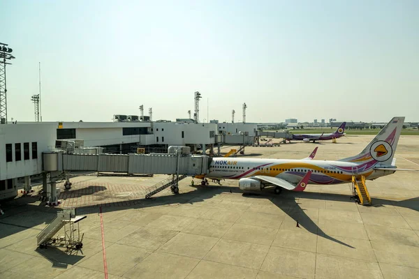 stock image Bangkok Thailand - May 19, 2023 ; Nok Air's airplane, a popular low-cost airline in Thailand, is parked at Don Mueang International Airport, ready to transport passengers on a clear and sunny day.