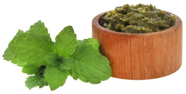 Tahta bir kasede taze yeşil yapraklı nane sosu.