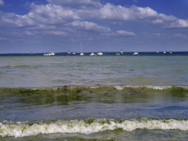 Waves and boats at Piriac-sur-Mer, a commune in the Loire-Atlantique department in western France clipart