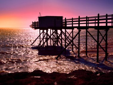 Sunset carrelet fishing at Fouras in France, also known as Fouras-les-Bains, is a commune in the French department of Charente-Maritime, administrative region of Nouvelle-Aquitaine in Poitou-Charentes.It lies 34km south of La Rochelle   clipart