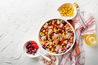 Healthy tuna salad with corn, peppers and beans on white background. Mexican corn salad.