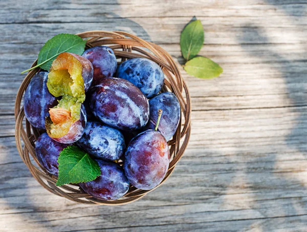 Basket Fresh Ripe Plums Wooden Background Outdoors Sunny Day — Stock Photo, Image