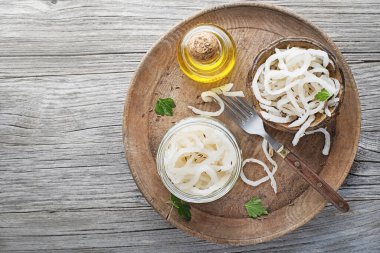 Traditional fresh and healthy sour turnip in glass jar on wooden background.