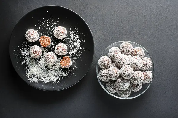 stock image Delicious Coconut-Chocolate balls covered with grated coconut. Soft, delicious and fudgy coconut balls with rum, biscuit and chocolate.