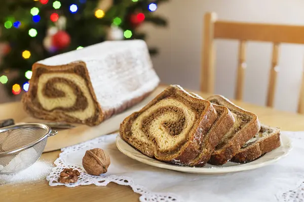 Noel tatili tatlısını kutluyor. Geleneksel Sloven ekmeği potica noel ağacının önünde.