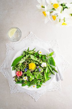 Karahindiba salatası, kuşkonmaz, yabani sarımsak, çiçekler ve ısırgan otu. Bahar deto 'su için sağlıklı yiyecek.