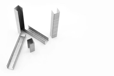 Metal staples for industrial and office stapler close-up on a white background