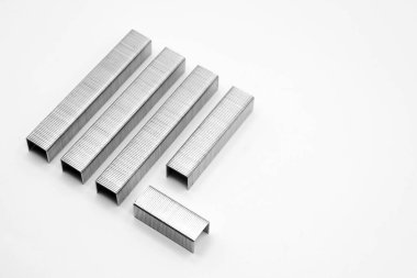 Metal staples for industrial and office stapler close-up on a white background
