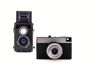 two black retro film cameras, 135 mm and medium format, close-up, on a white background, side view clipart
