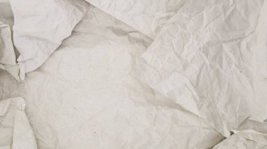 Textured background made of crumpled and neatly unfolded craft paper with a light gray tint, texture or background for design and decoration, abstract paper backdrop
