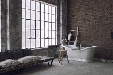 Küveti ve minimalist yatağı olan bir sanayi dairesi.