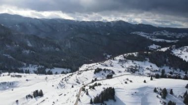 Aerial winter view of Rhodope Mountains around village of Stoykite and Pamporovo, Smolyan Region, Bulgaria