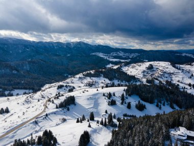 Aerial winter view of Rhodope Mountains around village of Stoykite and Pamporovo, Smolyan Region, Bulgaria