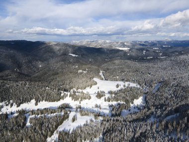 Aerial winter view of Rhodope Mountains around village of Stoykite and Pamporovo, Smolyan Region, Bulgaria