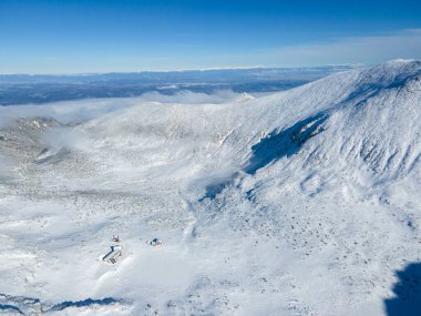 Amazing Aerial Winter view of Rila mountain near Musala peak, Bulgaria clipart