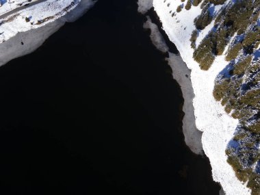 Aerial winter view of Beglika Reservoir covered with ice, Pazardzhik Region, Bulgaria clipart
