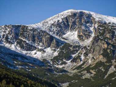 Amazing Autumn landscape of Rila Mountain near Mechit and Popova Kapa peaks, Bulgaria clipart