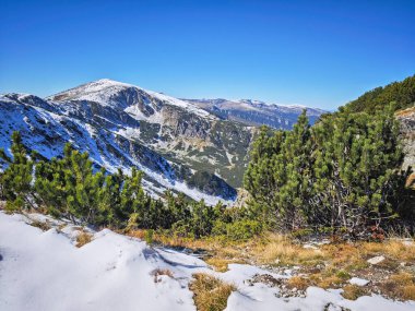 Amazing Autumn landscape of Rila Mountain near Mechit and Popova Kapa peaks, Bulgaria clipart