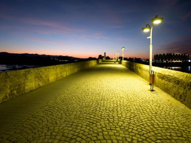 Sunset view of Sixteenth century Mustafa Pasha Bridge (Old Bridge) over Maritsa river in town of Svilengrad, Haskovo Region, Bulgaria clipart