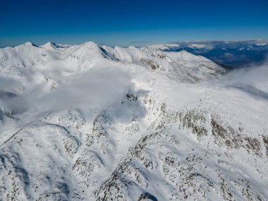 Amazing Aerial Winter view of Pirin Mountain near Polezhan and Bezbog Peaks, Bulgaria clipart