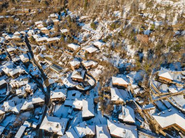 Aerial Winter Sunset view of Village of Kovachevitsa with Authentic nineteenth century houses, Blagoevgrad Region, Bulgaria clipart